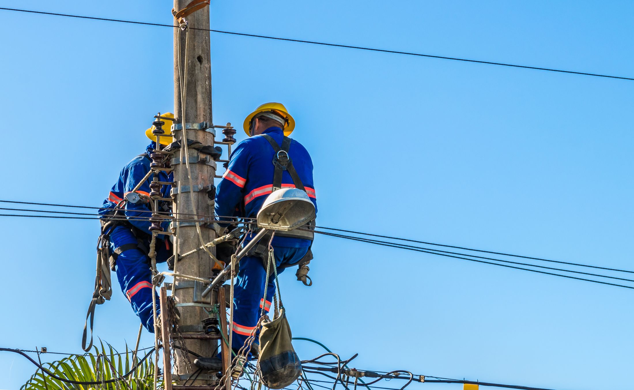 Utility workers repairing power lines, field application of USABAND hardware